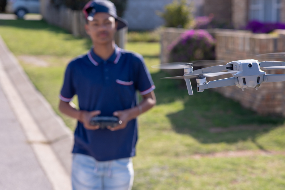 Young Boy Operating Drone Outdoors