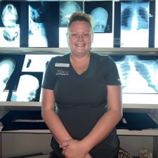 Sarah Cassell, VGCC Radiography Student standing in front of X-Rays.